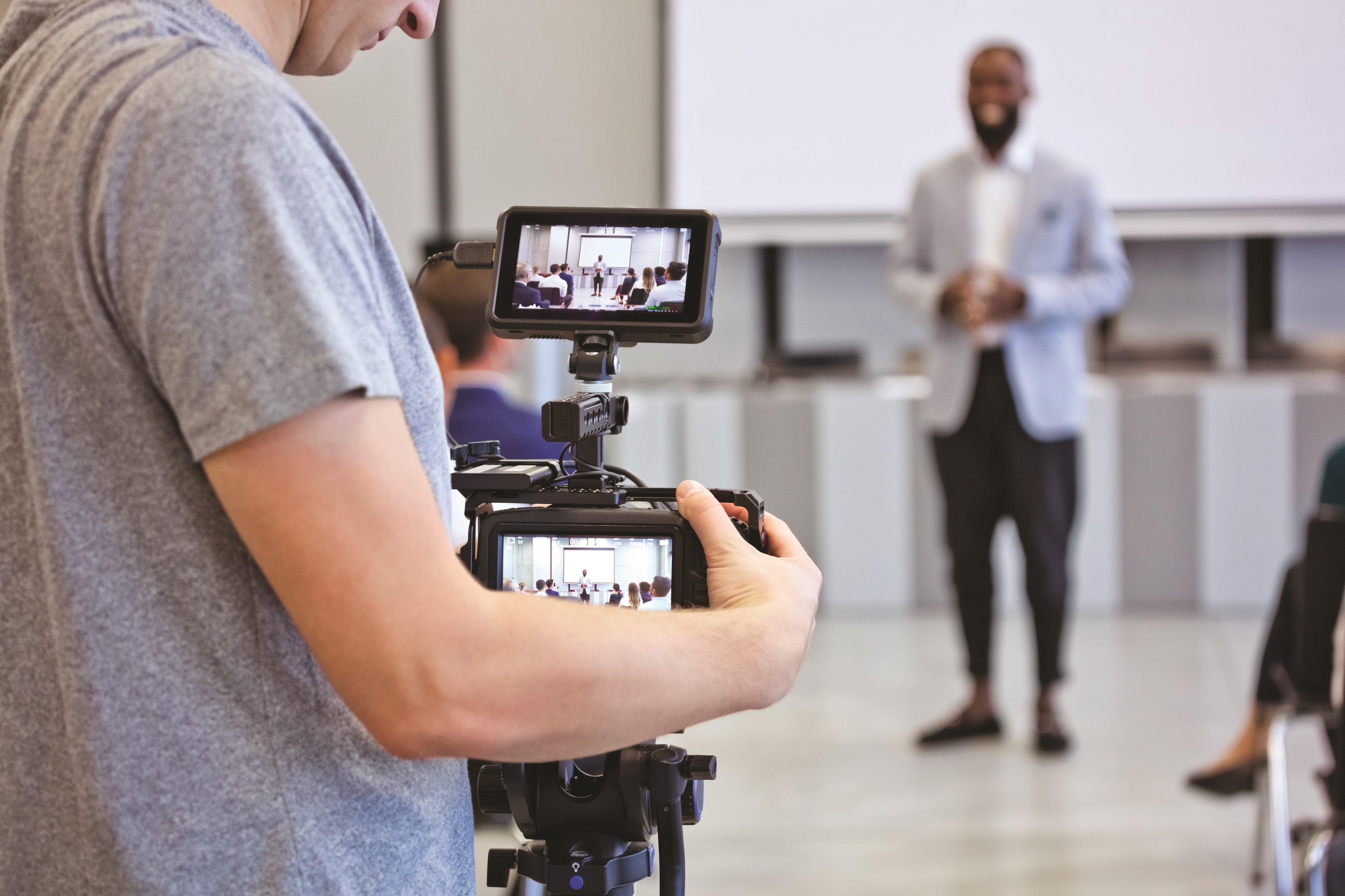 Shot of a man using a camera to shoot a corporate event